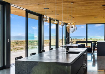 feature kitchen, dark kitchen, black kitchen, cedar ceiling, large joinery, large windows, polished concrete